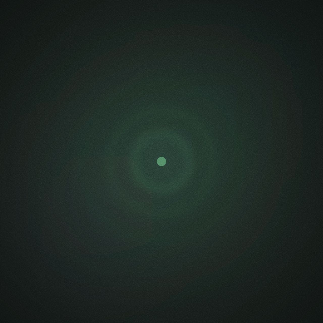 Dark forest green-black field. Four concentric glowing green rings radiate outward from a bright point at the center.