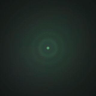 Dark forest green-black field. Four concentric glowing green rings radiate outward from a bright point at the center.